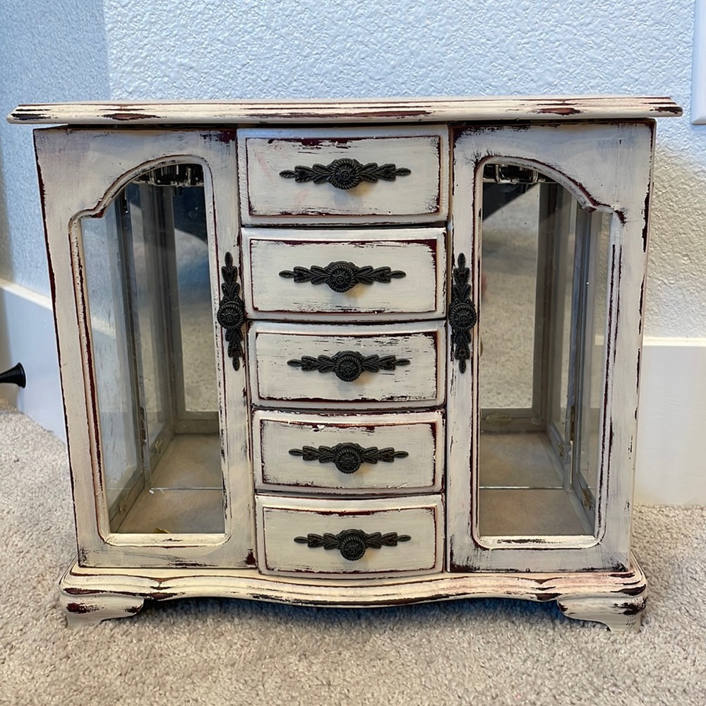 Large Jewelry case. 2 hanging racks for necklaces.  Two ring racks. 5 drawers.